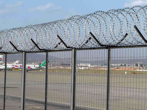 With razor barbed wire topping, welded wire security fence is installed at the airport.