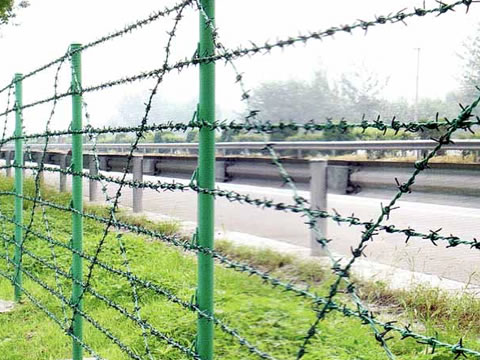 PVC coated barbed wires are installed on the frames along the highway.